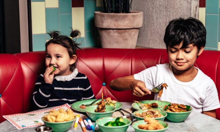 Rosa's Thai kids menu Young boy and girl eating from the Kids' Menu at Rosa's Thai
