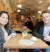 Alex and Saiphin smiling at a table in a Rosa's Thai café