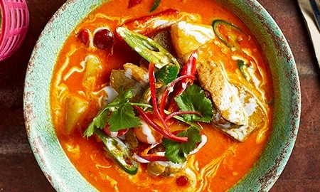 Thai red curry served in a green bowl