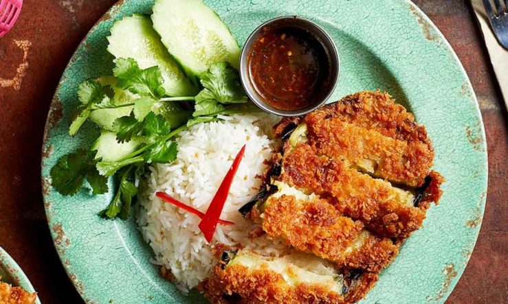 Rosa's Thai chicken served on a pale green plate with cucumber garnish, rice and dipping sauce