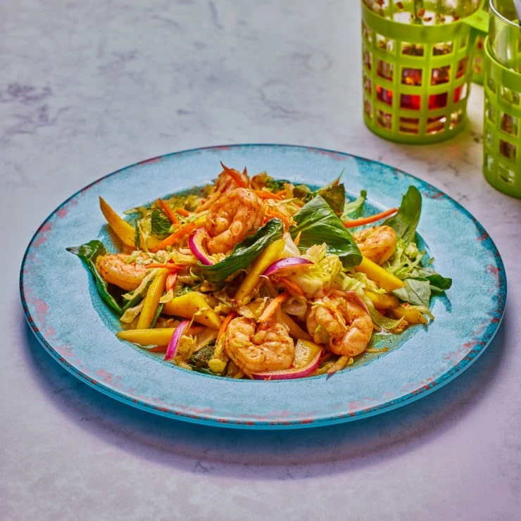 fresh salad on blue plate and white background