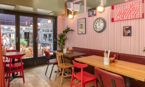 restaurant interior pink wall red chairs